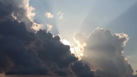 Dramatic Sunlight Breaking Through Dark Storm Clouds in the Sky Stock Footage 346622146