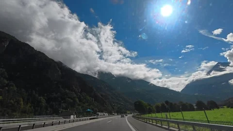Dramatic Sunlight Breaking Through Storm Clouds Over Swiss Alps 4K Stock Footage 340900022