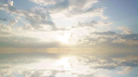 Dramatic sunlight breaks through moving clouds in a seamless mirrored... 스톡 동영상 344745210