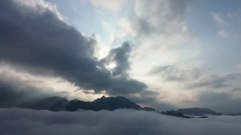 Dramatic sunrays cascade over mystical peaks enveloped in a vast ocean of t.. Stock-Footage 337278695