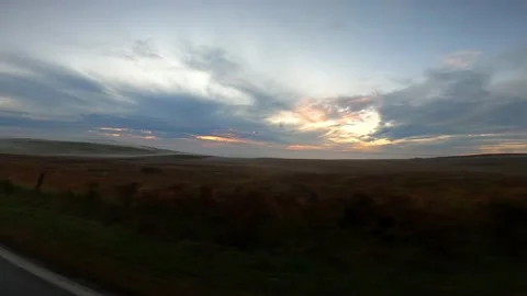 Dramatic sunrise North Coast 500 from moving car Stock Footage 150124157