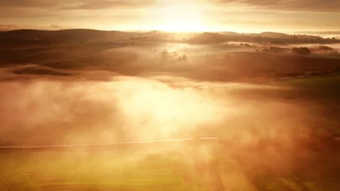 Dramatic sunrise over misty golden illuminated landscape Stock Footage 340968875
