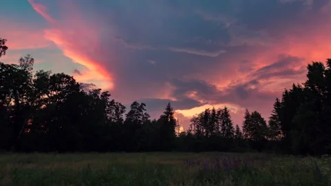 Dramatic sunrise sky over meadow and forest in 4k time lapse. Stock Footage 154368104