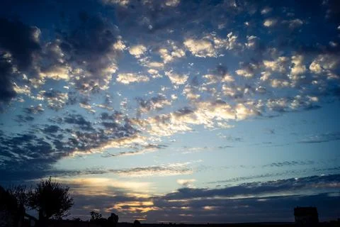 Dramatic sunrise sky with vibrant cloud cover over rural Andalusian country.. Stock Photos