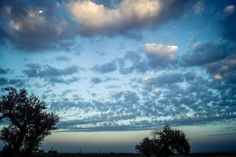 Dramatic sunrise sky with vibrant cloud cover over rural Andalusian country.. Stock Photos