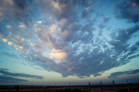 Dramatic sunrise sky with vibrant cloud cover over rural Andalusian country.. Stock Photos