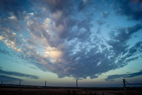 Dramatic sunrise sky with vibrant cloud cover over rural Andalusian country.. Stock Photos