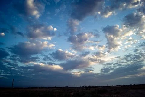 Dramatic sunrise sky with vibrant cloud cover over rural Andalusian country.. Stock Photos