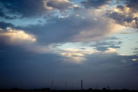Dramatic sunrise sky with vibrant cloud cover over rural Andalusian country.. Stock Photos