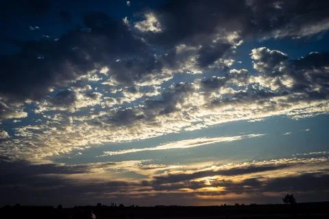 Dramatic sunrise sky with vibrant cloud cover over rural Andalusian country.. Stock Photos