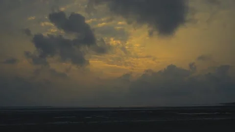 Dramatic Sunrise Time Lapse over Coastal Ocean Beach with Dark Clouds Stock Footage 239171433