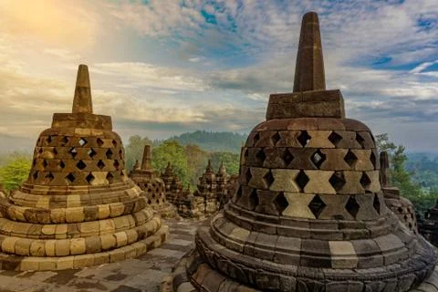 Dramatic sunrise view ancient stupa borobudur temple. the world's largest Bud Stock Photos