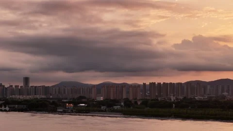 Dramatic sunset aerial of city skyline and storm clouds in China Stock Footage 337887354