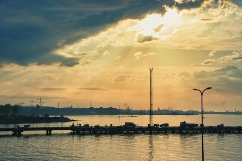 Dramatic Sunset and Sun Rays over Tallinn Port Pier Silhouette Stock Photos