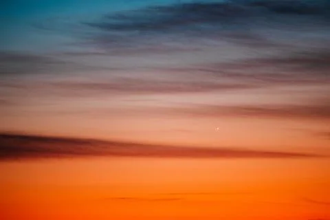 Dramatic sunset and sunrise gradient sky with orange blue and pink clouds Stock Photos