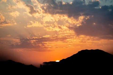 Dramatic  sunset behind a mountain Stock Photos