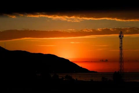 Dramatic sunset behind of mountain silhouette Stock Photos
