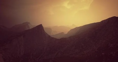 Dramatic sunset casting golden light over rugged mountain landscape Stock Illustration