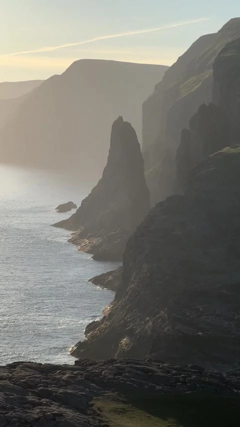 Dramatic sunset cliffs where the lake meets the ocean at Traelanipa, Faroe  Stock Footage 331254585