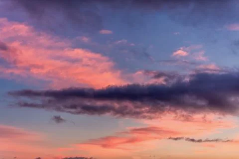 Dramatic sunset with clouds and pink orange blue sky Stock Photos