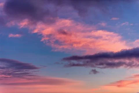 Dramatic sunset with clouds and pink orange blue sky Stock Photos