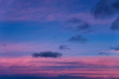Dramatic sunset with clouds and pink orange blue sky Stock Photos