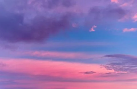 Dramatic sunset with clouds and pink orange blue sky Stock Photos