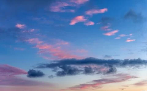 Dramatic sunset with clouds and pink orange blue sky Stock Photos
