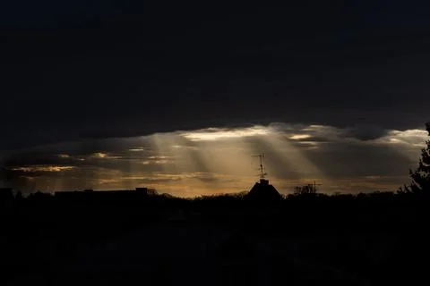 Dramatic sunset with clouds and rays of the sun. Stock Photos