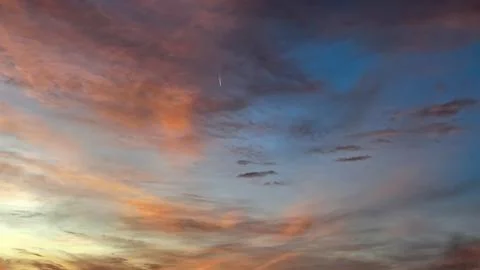 Dramatic Sunset Clouds Blending Across Evening Sky Stock Photos