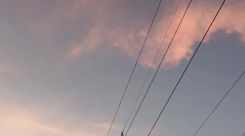 Dramatic sunset clouds with electric transmission tower wire. Stock-Fotos