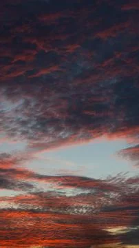 Dramatic Sunset Clouds in Fiery Hues 스톡 사진