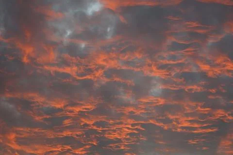 Dramatic Sunset Clouds with Fiery Red and Orange Hues in Evening Sky Stock Photos