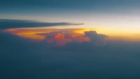 Dramatic Sunset Clouds Glowing Orange and Pink Above Blue Atmospheric Haze. Stock Footage 338360496