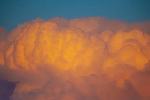 Dramatic sunset clouds illuminated with shades of orange and yellow against.. 写真素材