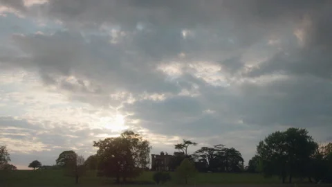 Dramatic sunset clouds moving over english countryside manor Stock Footage 328163697