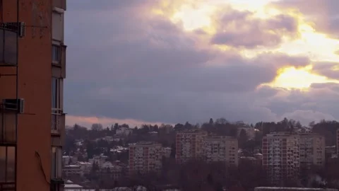 Dramatic sunset clouds moving over residential apartment complex in winter .. Video stock 337644718