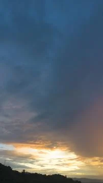 Dramatic Sunset Clouds Over Dark Silhouetted Hills Stock Photos