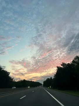 Dramatic sunset clouds over the New Jersey Turnpike highway Photos