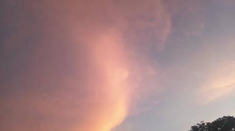 Dramatic sunset clouds with power lines and electrical cables in the evening sky Stock Photos
