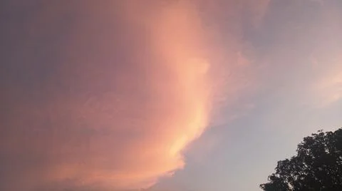 Dramatic sunset clouds with power lines and electrical cables in the evening sky Stock Photos