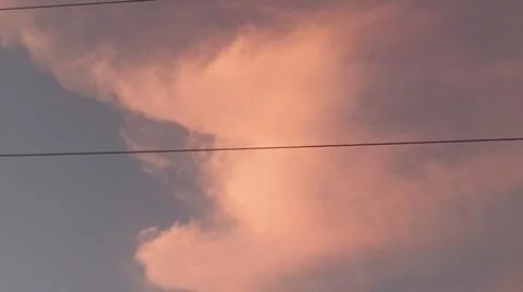 Dramatic sunset clouds with power lines and electrical cables in the evening sky Stock Photos