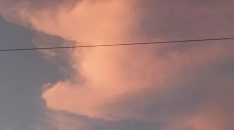 Dramatic sunset clouds with power lines and electrical cables in the evening sky Stock Photos