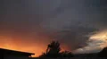 Dramatic sunset colored storm clouds with lightning strike slo-mo 2 HD Footage