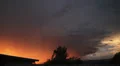 Dramatic sunset colored storm clouds with lightning strike slo-mo 1 HD Footage