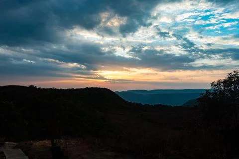 Dramatic sunset colorful sky over mountain shadow at morning from flat angle Foto stock