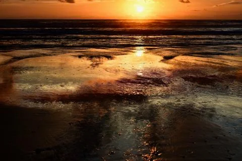 Dramatic sunset colours; beautiful sunset on a beach. Stock Photos