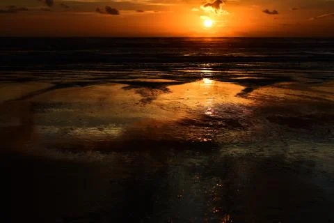 Dramatic sunset colours; beautiful sunset on a beach. Stock Photos