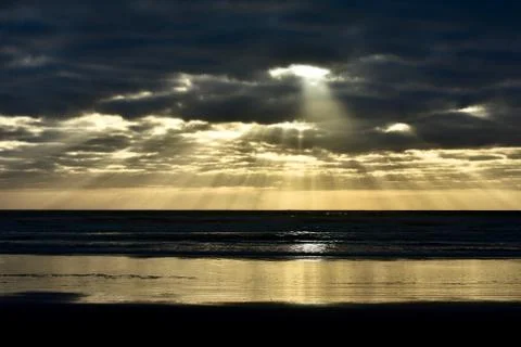 Dramatic sunset colours; beautiful sunset on a beach. Stock Photos