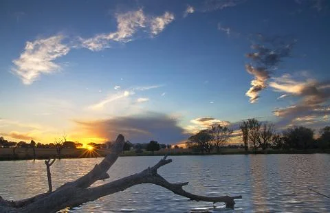 Dramatic sunset with dead tree Stock Photos